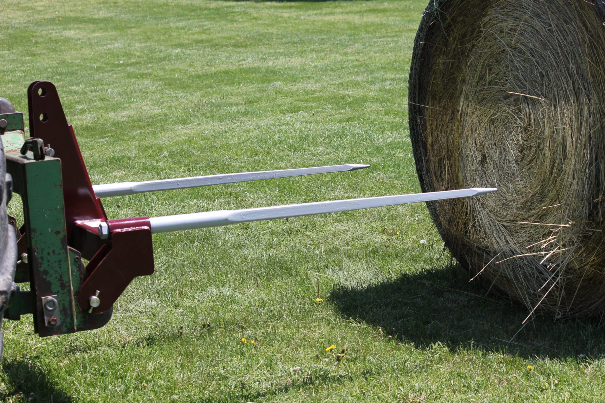 3-Point Double Quick-Hitch hay bale spear beginning to pierce a big bale
