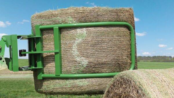 big bale grabber lifting a large hay bale