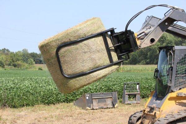 big bale grabber lifting a large hay bale