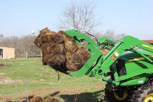 Sub Compact Grapple lifting a large tree
