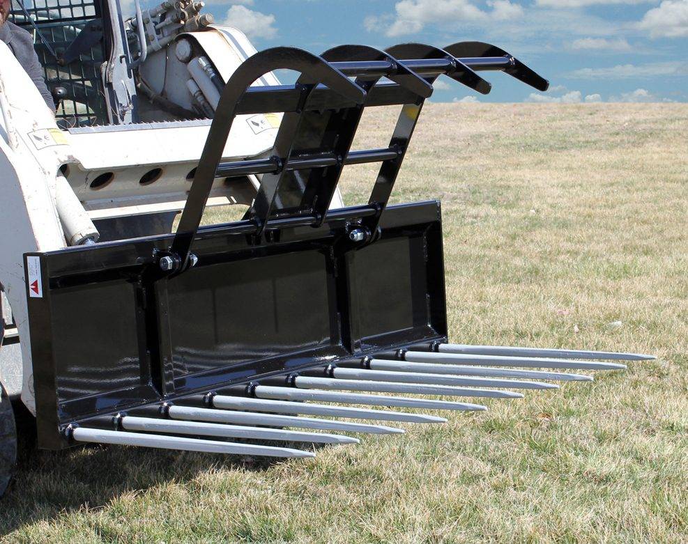 manure grapple in use in field