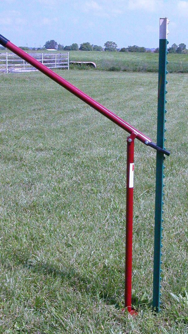 Fence post puller being used in a field.