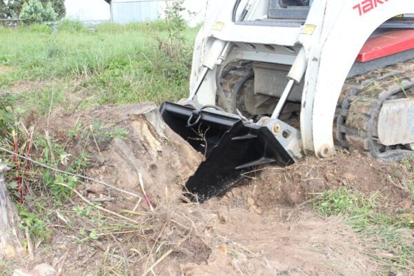 Stump Bucket digging into grassy area